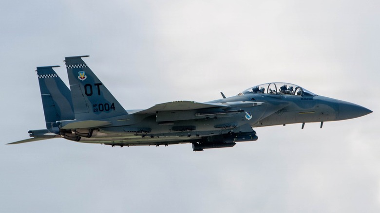 An F-15EX Eagle II flying over some clouds