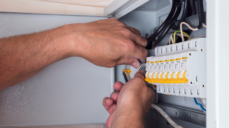 A worker adding a new line in a fusebox