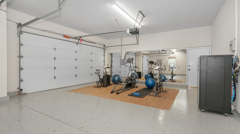 A garage being used as a home gym, equipped with workout equipment