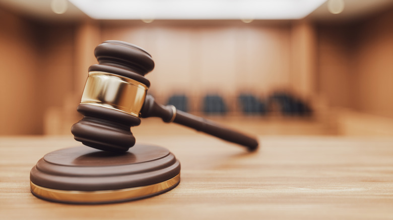 Closeup of a wooden gavel in a courtroom.