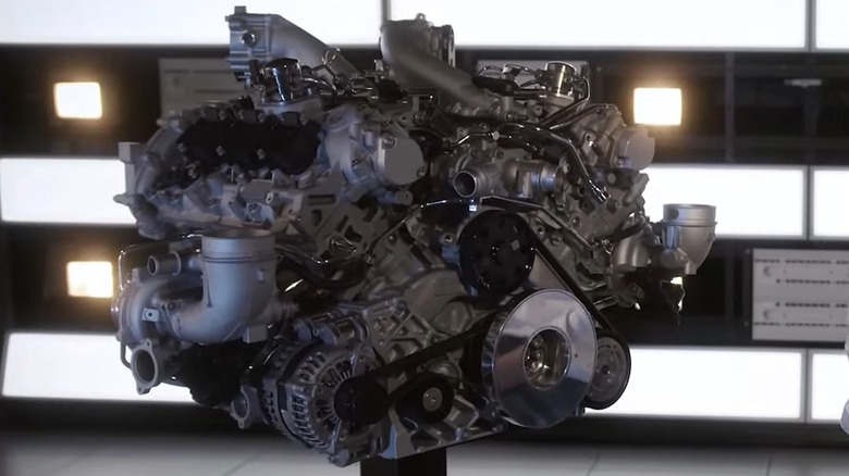 A fully assembled Nettuno V6 engine on display in a clean and well-lit presentation studio.