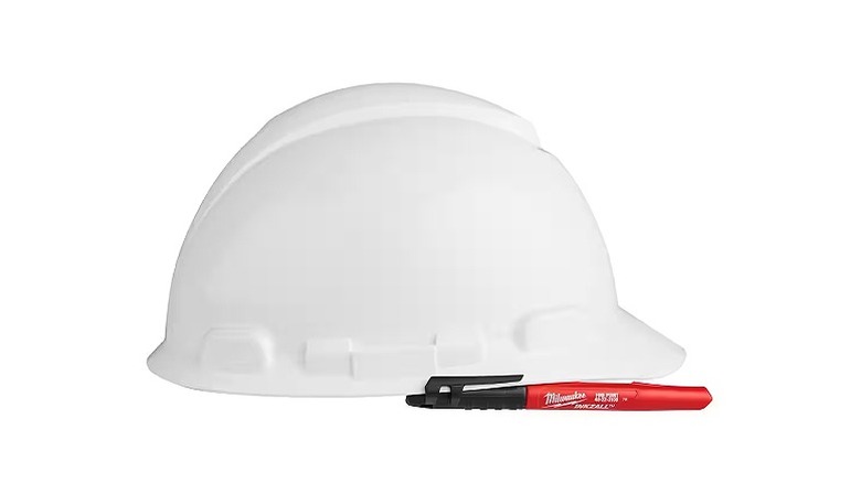 White construction helmet and Milwaukee marker
