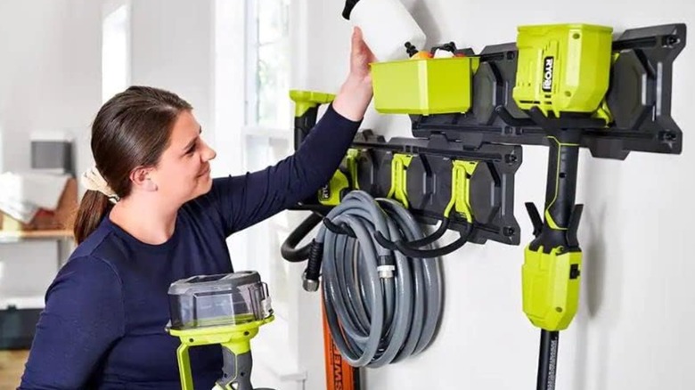 A homeowner using Link storage equipment mounted on a wall