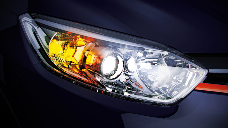 A zoomed-in view of headlights on a sedan.