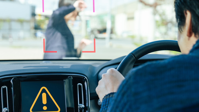 a pedestrian in front of a car