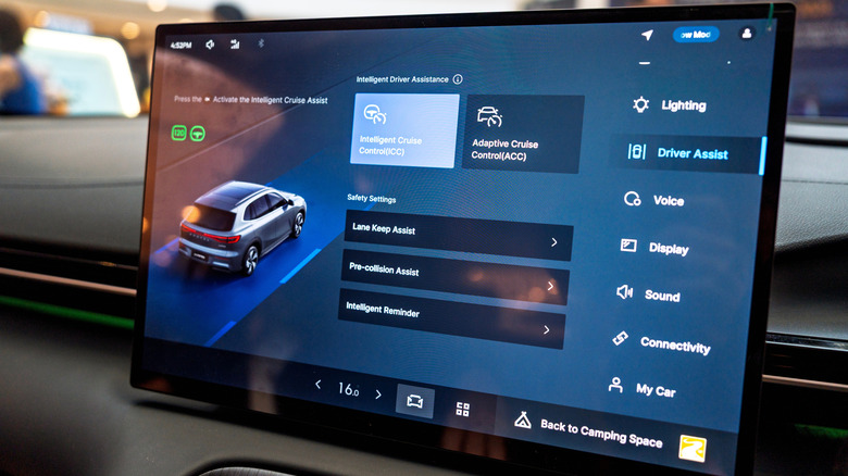A car's infotainment system showing driver assist features.