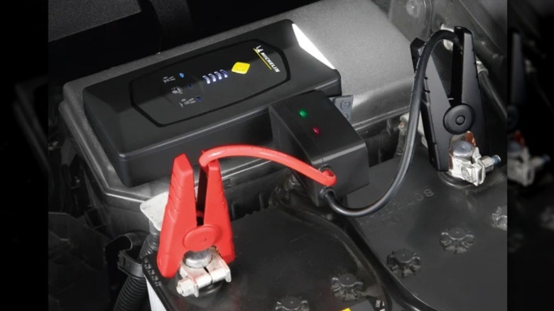 Michelin portable jump starter connected to a car battery