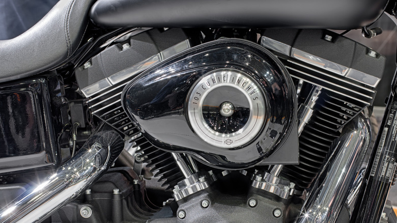 A close up shot of a black Harley-Davidson Street Bob Special showing the Twin Cam 103 engine in all its glory.