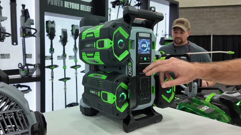 A person pressing a power button on the EGO POWER+ Nexus 1400W Portable Power Station