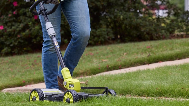 Woman using Ryobi PCLST05K 3-in-1 lawn tool
