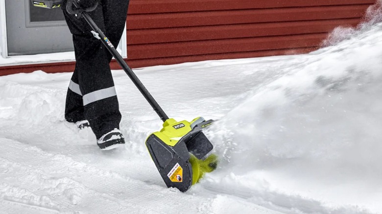 Person using Ryobi RY40SN01K Snow Shovel on walkway