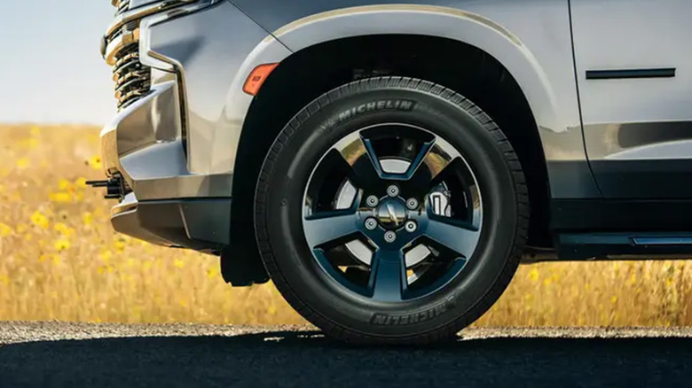 A Michelin tire on a silver SUV.