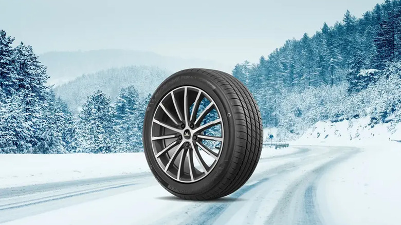 A Michelin Primacy Tour A/S tire on a wintry road.