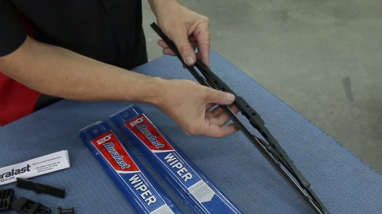 Person holding Duralast wipers over table