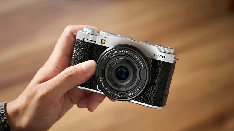 A person holding the Fujifilm X-M5