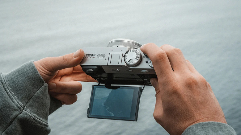A person shooting content with the Fujifilm X100VI