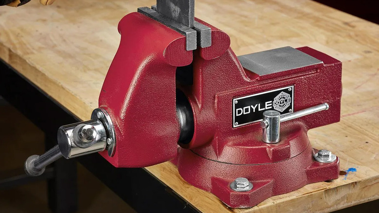A Doyle swivel vise holding a piece of metal