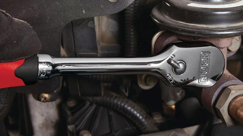An Icon brand ratchet working on a car's engine bay