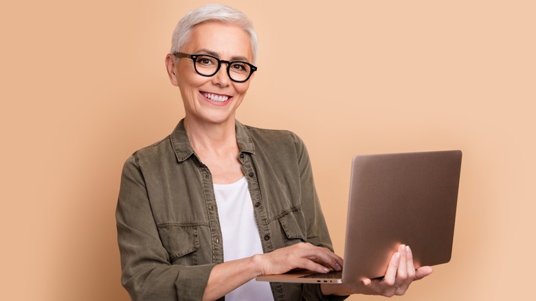 smiling woman using laptop