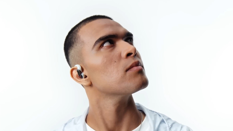 Man looking to a side while wearing Nothing Ear Open Ear Headphones.