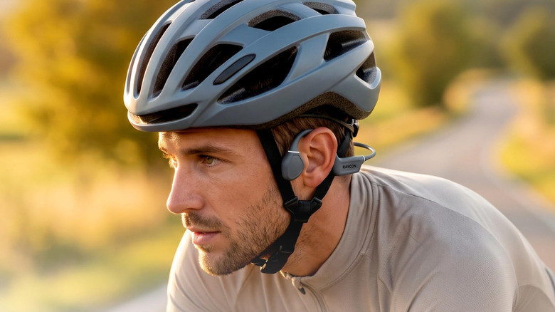 Man on bycicle wearing Raycon Open Ear Running Headphones.