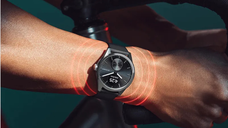 A person wearing a black Withings ScanWatch 2 on a bike.