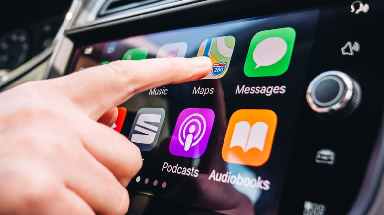 Finger taps map icon on CarPlay dashboard