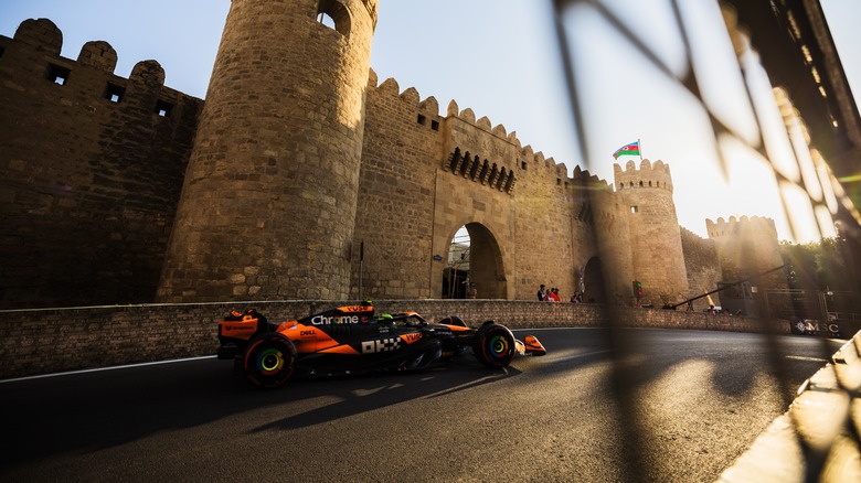 A shot of Lando Norris driving through the castle section of Baku City Circuit