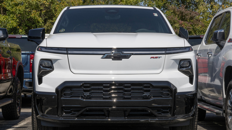 A white Chevrolet Silverado EV in a parking lot