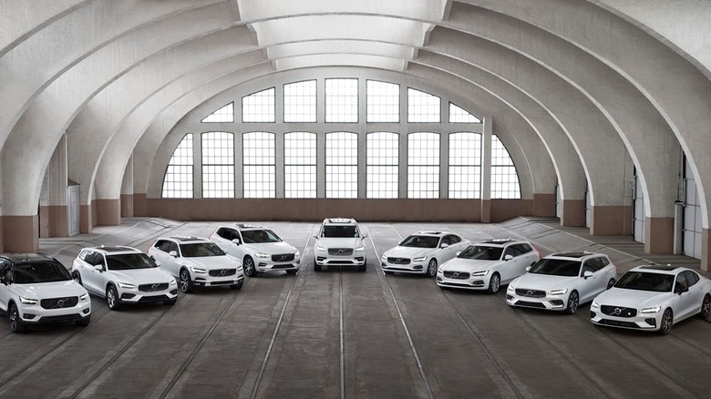 A lineup of all major volvo models currently on offer in 2025, all white, in a garage