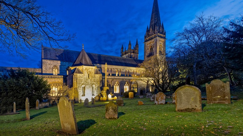 church in cemetery among gravestones
