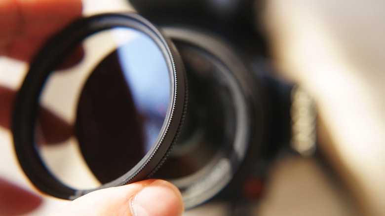 photographer attaching a filter