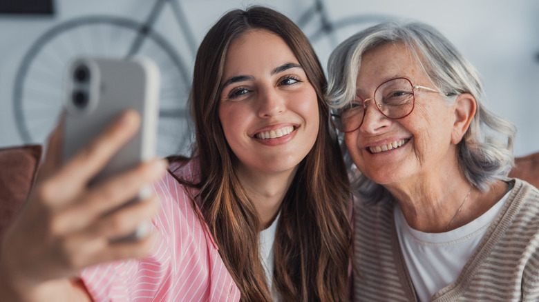 Two people taking a selfie with the phone's front cameras.