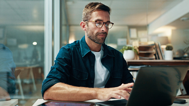 Image of someone researching on a laptop.
