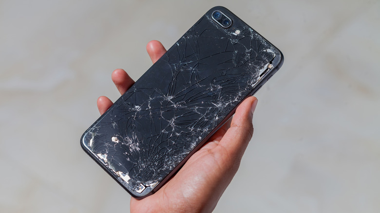 Picture of a phone with a thoroughly cracked screen.