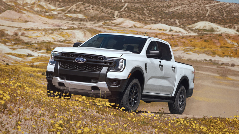 A white 2026 Ford Ranger driving off-road