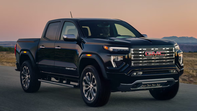 A black 2026 GMC Canyon driving
