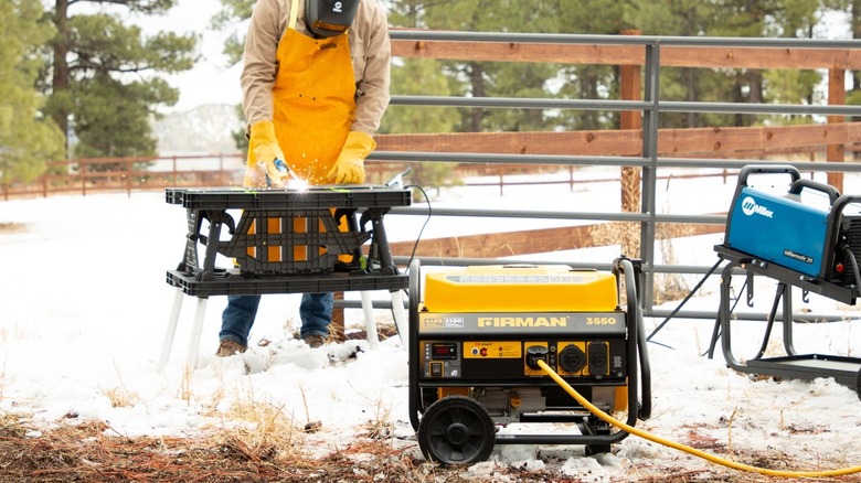Person using Firman generator outside