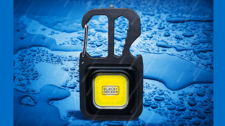 The Black & Decker Square Auto-Lock Carabiner multitool on a blue, wet background