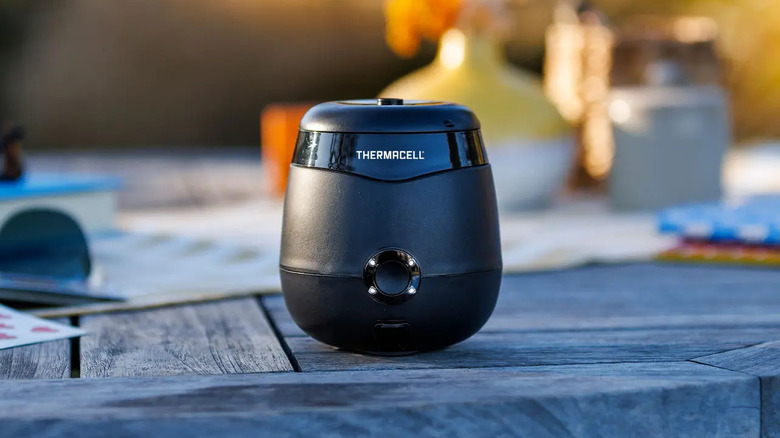 The Thermacell E55 E-Series Rechargeable Mosquito Repeller on a wooden table