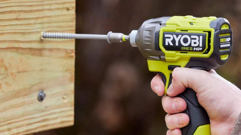 A Ryobi Hex Impact Driver driving a screw into wood.