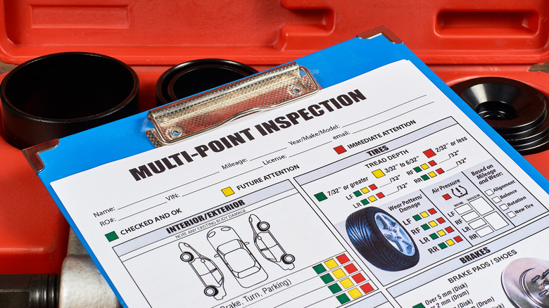 Vehicle multi-point inspection sheet on a clipboard