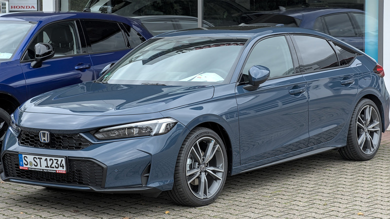 A blue Honda Civic Hybrid parked in a parking lot
