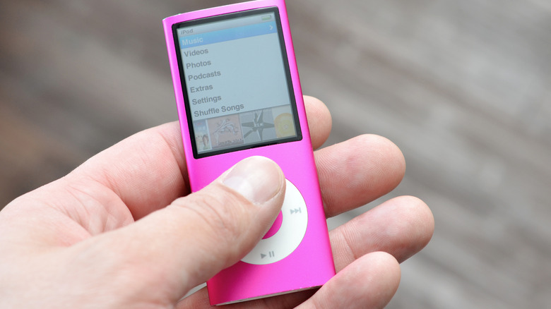 An old-school, pink iPod Nano in a hand.