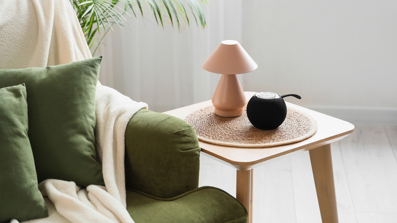 A smart speaker on a woven mat.