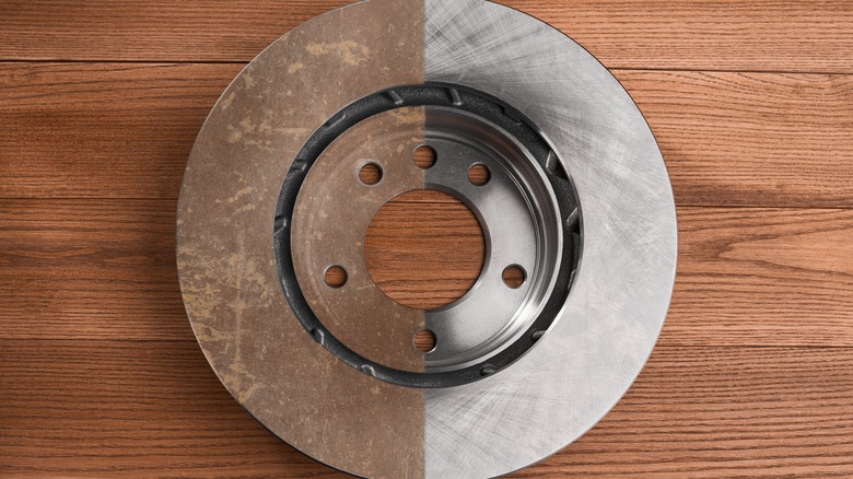 Partially cleaned brake rotor with rust on one side.