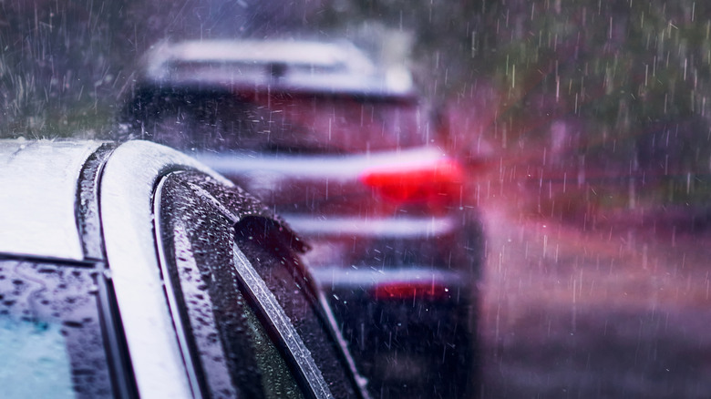 Illuminated brake lights in a rain storm.