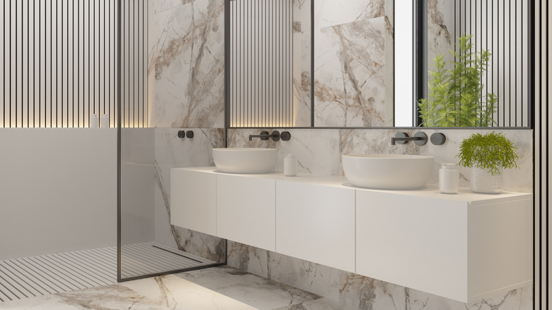 A modern bathroom layout with plants, mirrors, and sinks