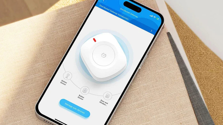 GoveeLife Wireless Mini Smart Button Sensor laying on phone.