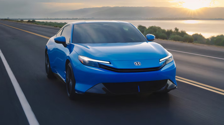 A blue 2027 Honda Prelude driving